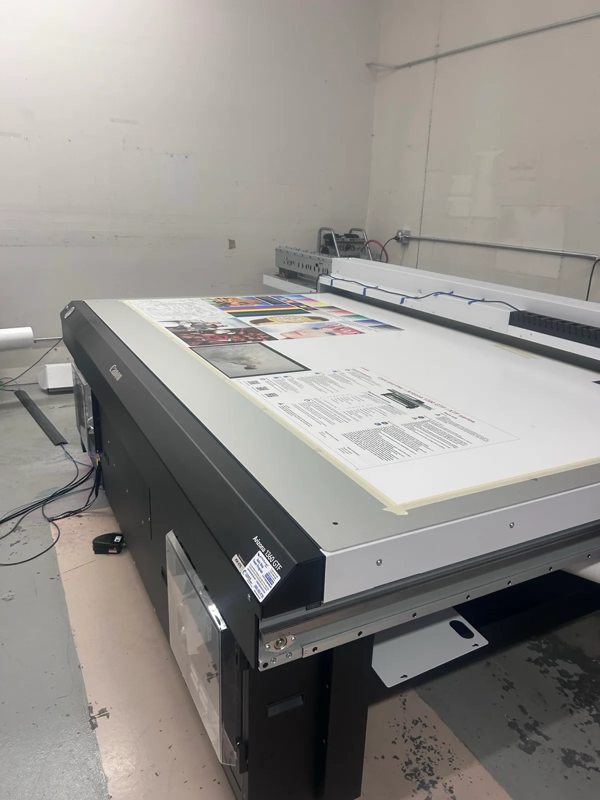 Color charts, photographs, and fine text printed on a sample sheet on the Canon Arizona 1360 GTF table